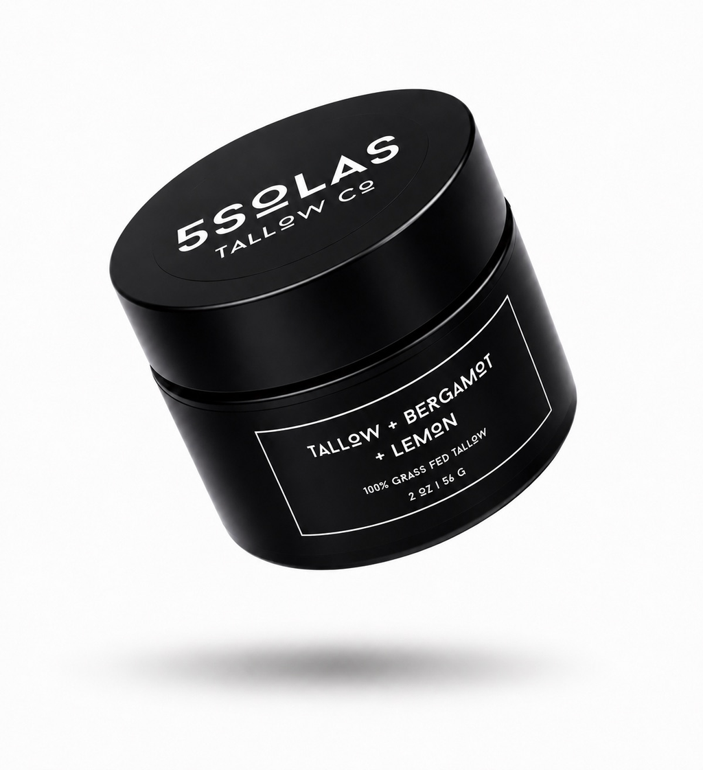 A black cylindrical cosmetic jar with a matching lid, floating at an angle on a light gray background. The lid and label are printed with white text reading '5SOLAS TALLOW CO' and 'TALLOW + BERGAMOT + LEMON'.