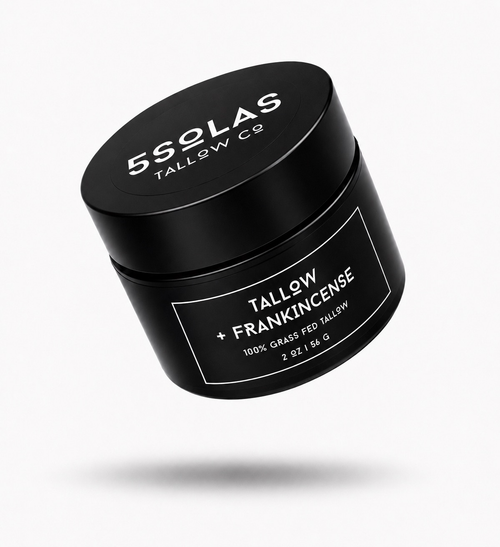 A black cylindrical cosmetic jar with a matching lid, floating at an angle on a light gray background. The lid and label are printed with white text reading '5SOLAS TALLOW CO' and 'TALLOW + FRANKINCENSE'.