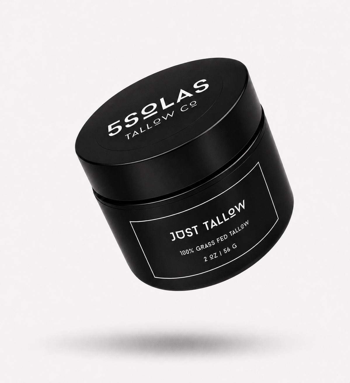 A black cylindrical cosmetic jar with a matching lid, floating at an angle on a light gray background. The lid and label are printed with white text reading '5SOLAS TALLOW CO' and 'Just Tallow'.