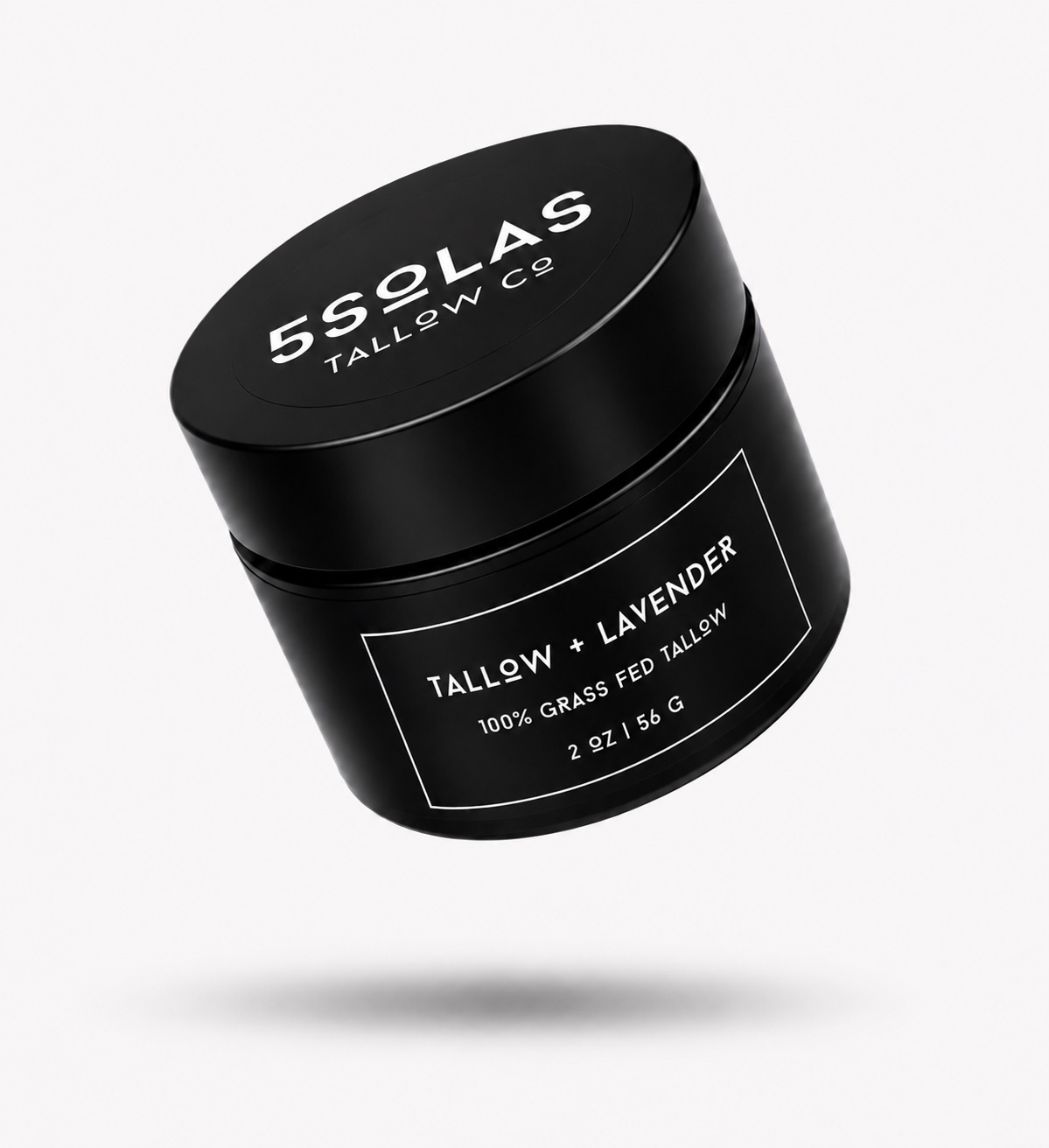 A black cylindrical cosmetic jar with a matching lid, floating at an angle on a light gray background. The lid and label are printed with white text reading '5SOLAS TALLOW CO' and 'TALLOW + LAVENDER'.